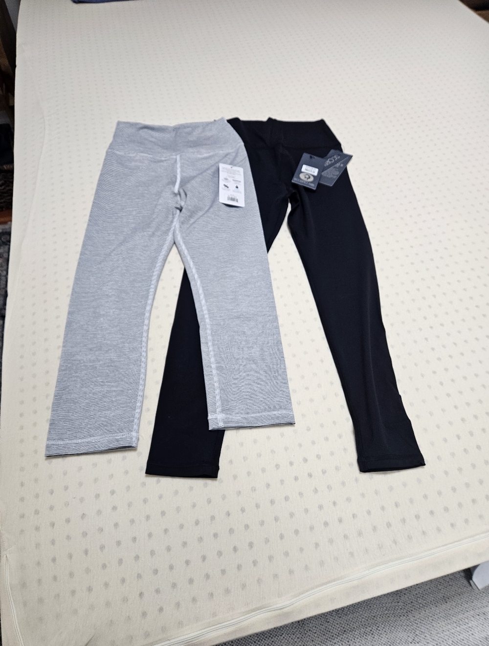 Scorpio Sol  Leggings Set of Two. One In Gray Pinstripe and one In Black.